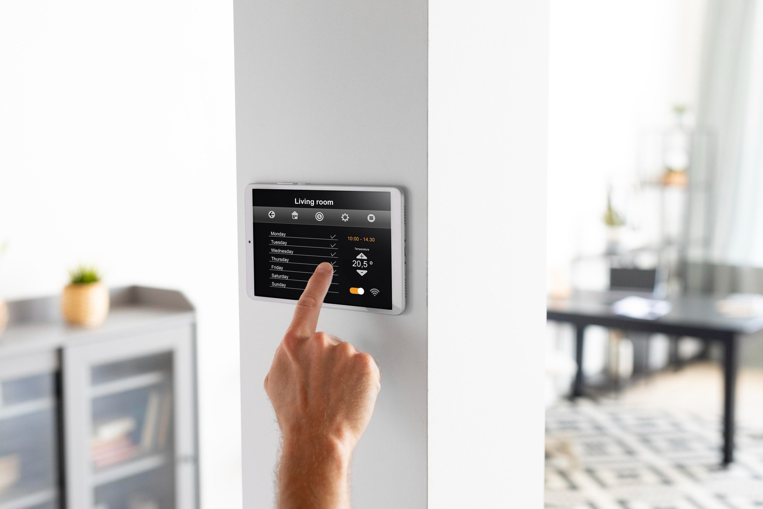 Man using tablet to control temperature and humidity